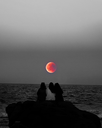 3 women looking at the moon