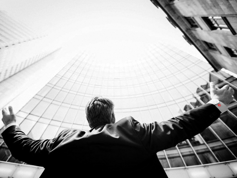 Business Man in Front of Building with Arms Open