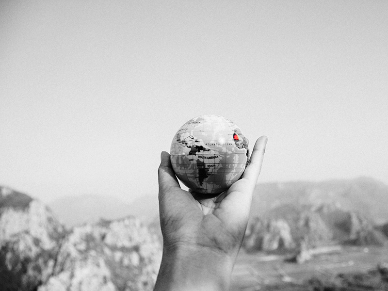 Hand holding a globe